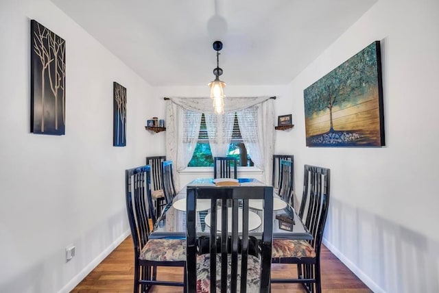 dining space with dark wood-style floors and baseboards