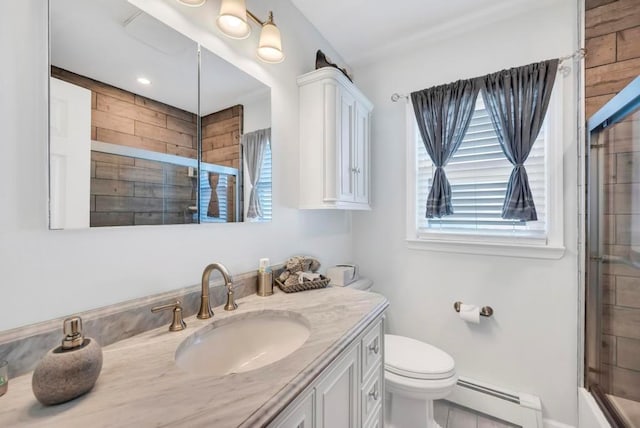 bathroom featuring toilet, baseboard heating, and vanity