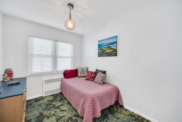 bedroom featuring radiator heating unit and baseboards