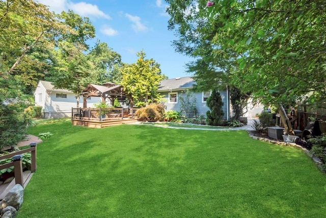 view of yard with a deck, a gazebo, and fence