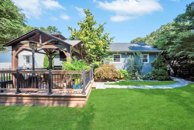 exterior space featuring a yard, a gazebo, roof with shingles, and a wooden deck