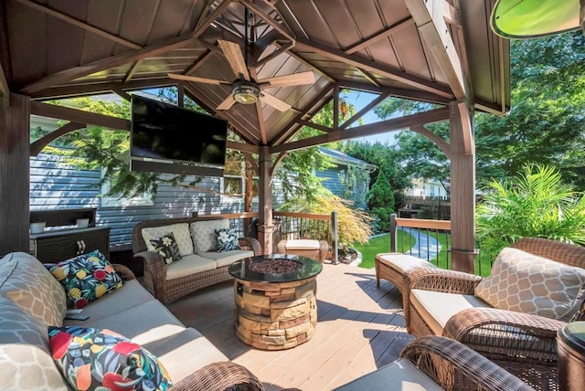 view of patio / terrace with an outdoor living space with a fire pit, ceiling fan, and a gazebo