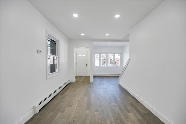 entrance foyer featuring recessed lighting, a baseboard radiator, wood finished floors, and baseboards