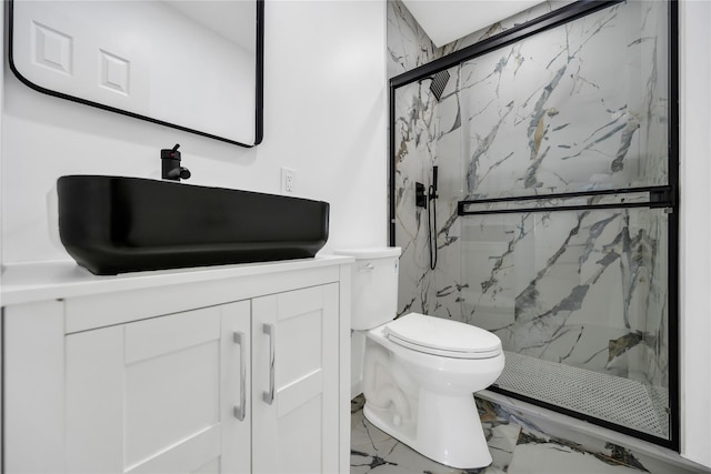 full bathroom with toilet, marble finish floor, a marble finish shower, and vanity