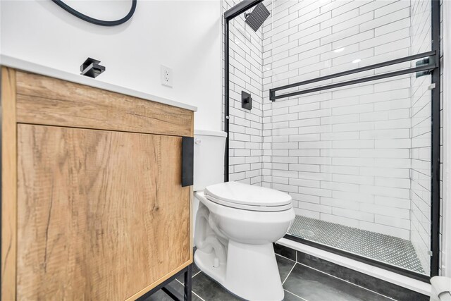 full bathroom with tile patterned flooring, a shower stall, and toilet