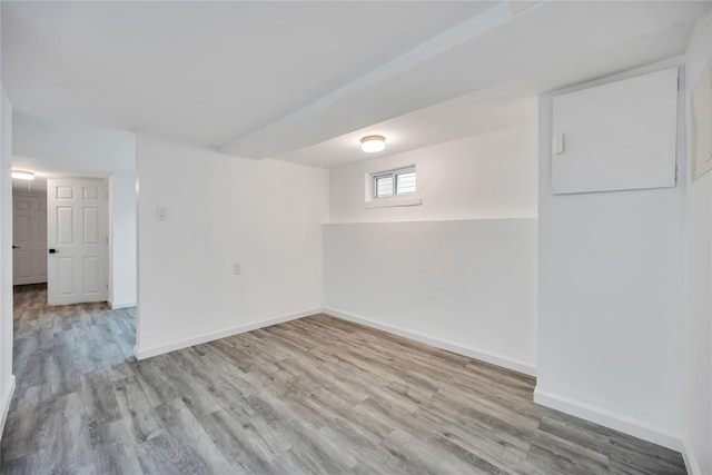 below grade area with wood finished floors and baseboards