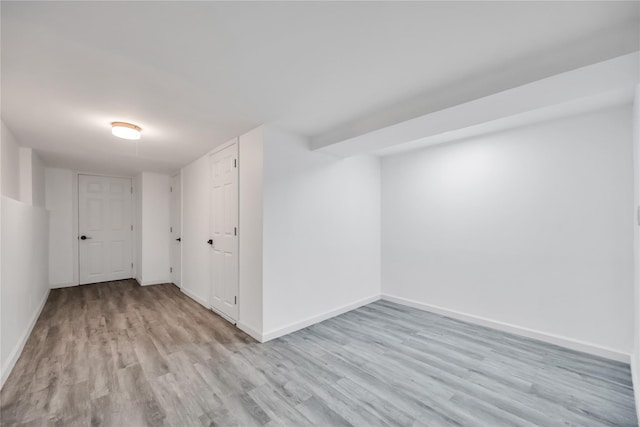 unfurnished room featuring wood finished floors and baseboards