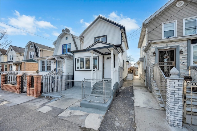 view of front of property featuring a fenced front yard and a gate