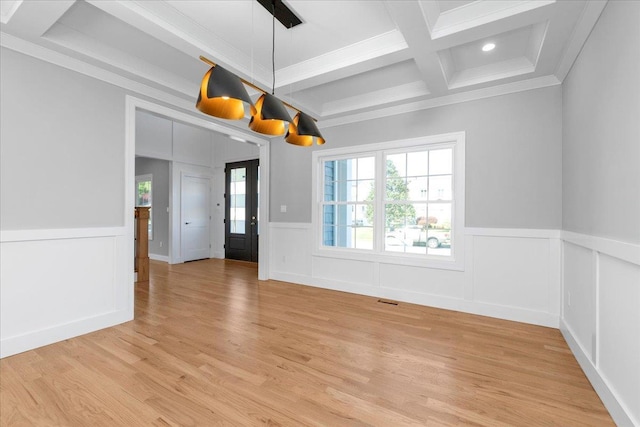 unfurnished dining area featuring wainscoting, coffered ceiling, beamed ceiling, and light wood finished floors