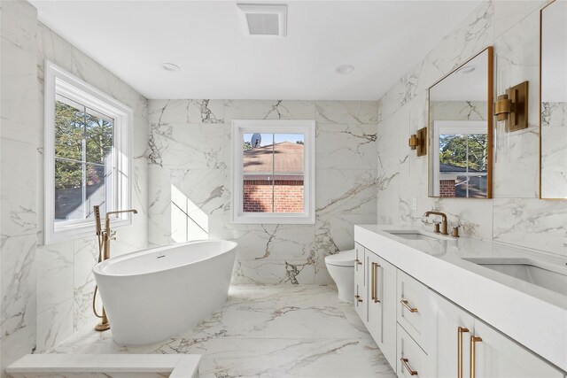 full bath with visible vents, toilet, marble finish floor, stone wall, and a sink