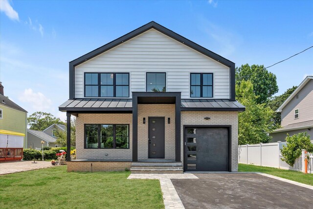 18 Anita Ave, Syosset, NY 11791 - contemporary home with brick siding, a standing seam roof, driveway, and a metal roof
