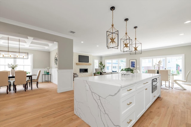 18 Anita Ave, Syosset, NY 11791 - kitchen featuring a chandelier, recessed lighting, light wood finished floors, a fireplace, and a center island