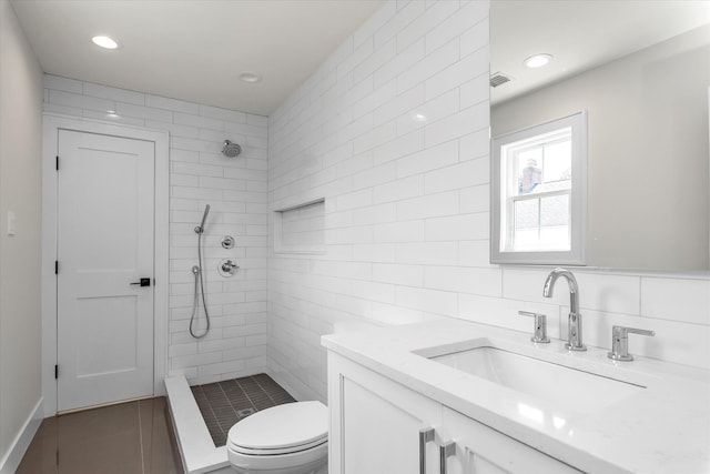 18 Anita Ave, Syosset, NY 11791 - bathroom featuring a tile shower, vanity, recessed lighting, tile walls, and tile patterned flooring