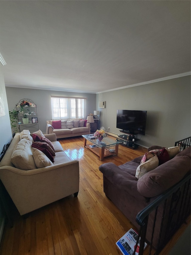 living room featuring ornamental molding, wood-type flooring, and an AC wall unit