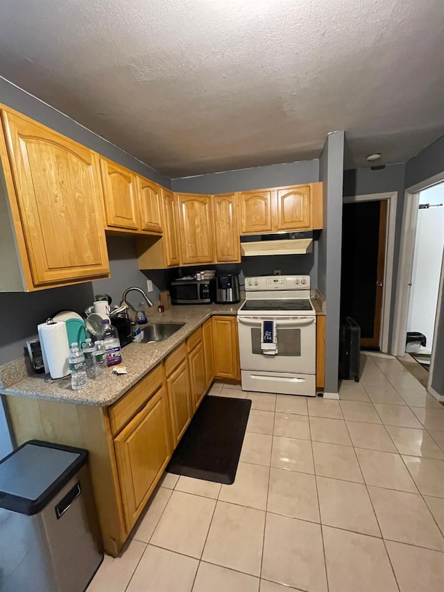 kitchen featuring light tile patterned floors, white electric range oven, stainless steel microwave, a sink, and under cabinet range hood