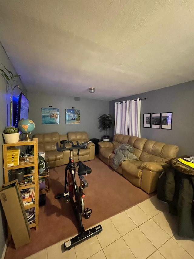 living area featuring a textured ceiling and tile patterned floors