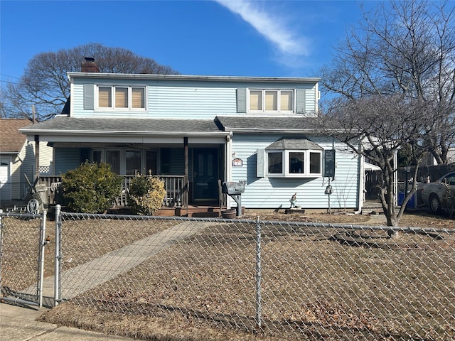 view of front of property with a fenced front yard, a chimney, and a porch