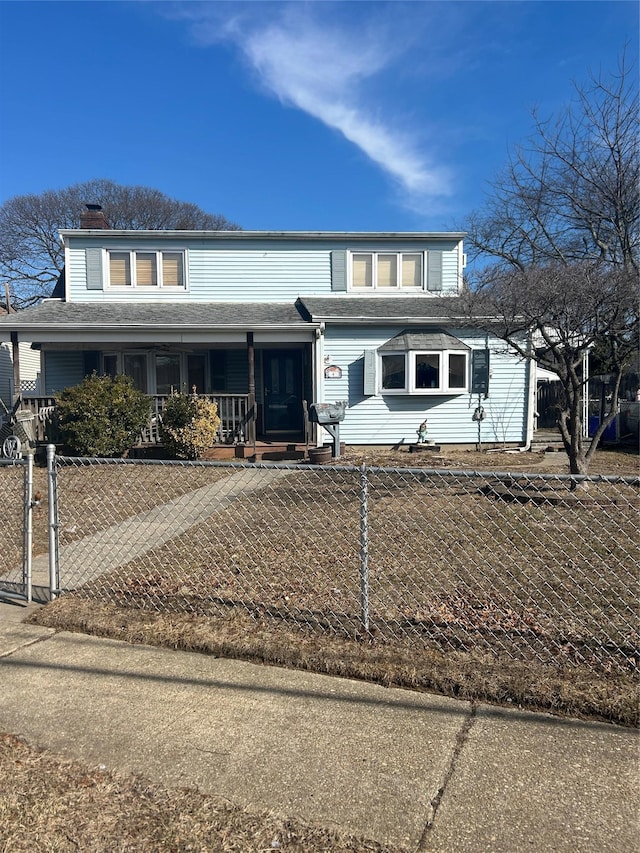 view of front of property with a fenced front yard, covered porch, and a chimney