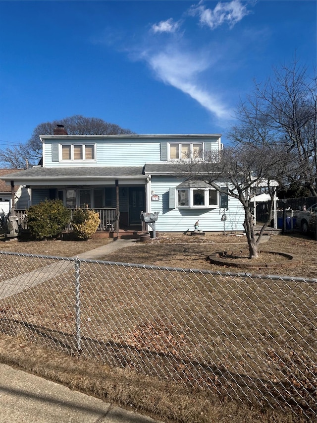 view of front of home with covered porch and fence