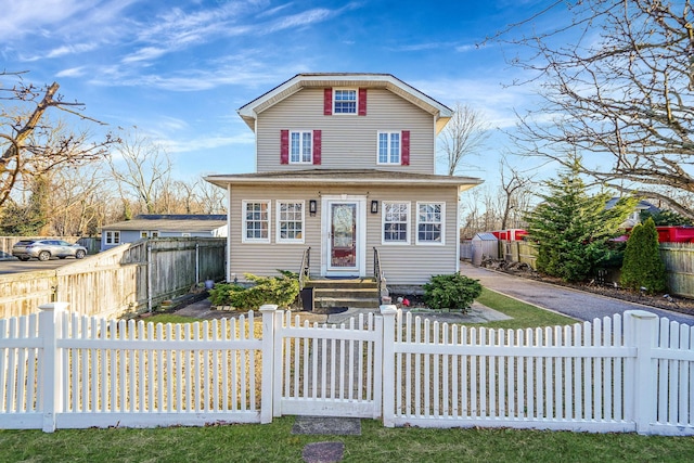 view of front of house featuring a fenced front yard and driveway