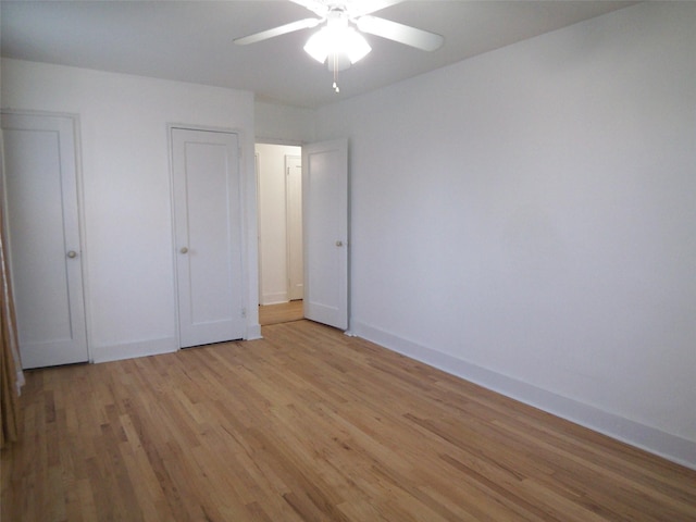 unfurnished bedroom featuring baseboards, ceiling fan, and light wood finished floors