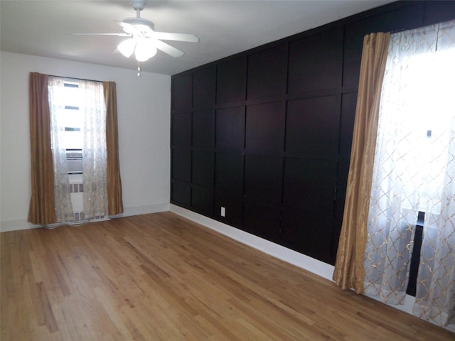 spare room featuring light wood-style flooring and a ceiling fan