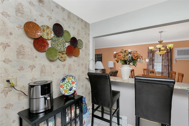 kitchen featuring wallpapered walls, a breakfast bar area, light stone counters, a peninsula, and an inviting chandelier