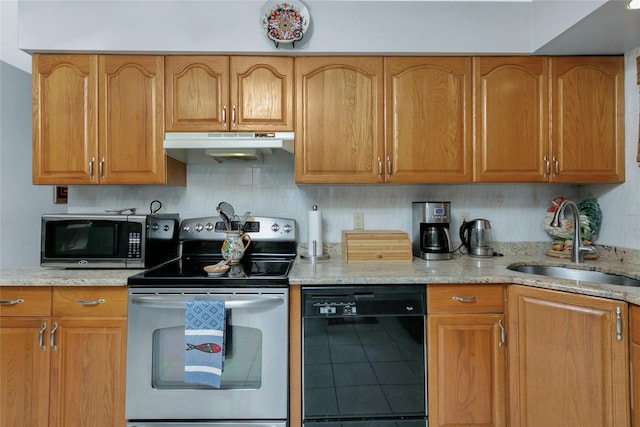 kitchen with stainless steel appliances, backsplash, a sink, light stone countertops, and under cabinet range hood