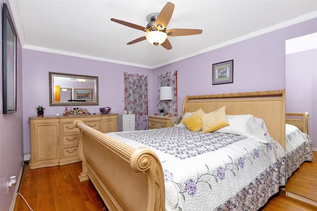 bedroom featuring a ceiling fan, dark wood-style flooring, a baseboard heating unit, and crown molding