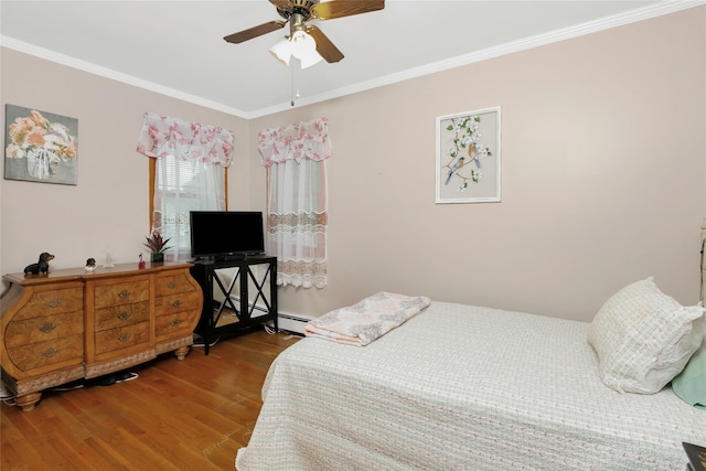 bedroom with a ceiling fan, ornamental molding, and wood finished floors