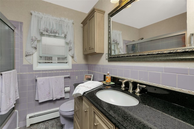 bathroom featuring shower / bath combination with glass door, tile walls, toilet, a baseboard heating unit, and vanity