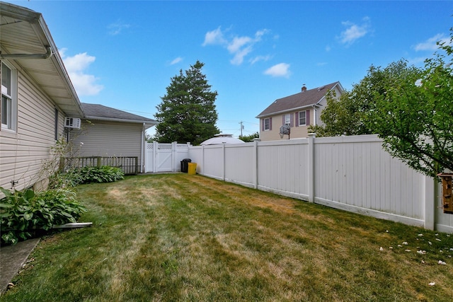 view of yard featuring a gate and a fenced backyard