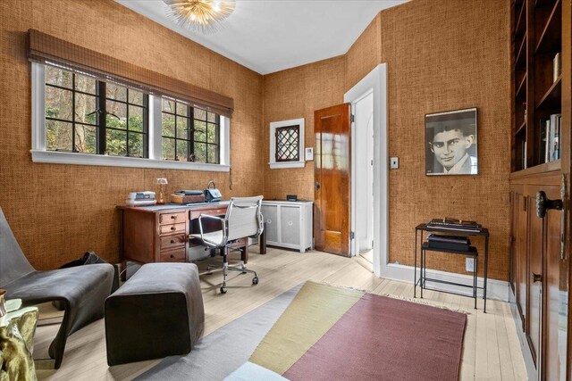 office space featuring light wood-type flooring and baseboards