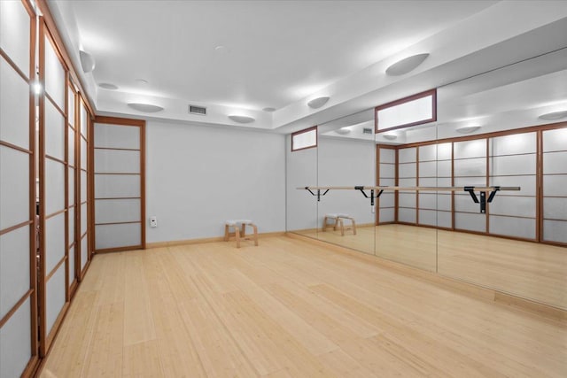 interior space with visible vents and wood finished floors