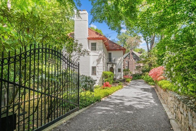 2737 Palisade Ave, Bronx, NY 10463 - view of home's exterior featuring a chimney, a tile roof, and stucco siding
