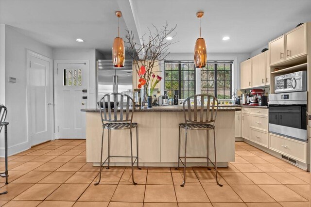 2737 Palisade Ave, Bronx, NY 10463 - kitchen featuring stainless steel appliances, a breakfast bar area, dark countertops, and recessed lighting