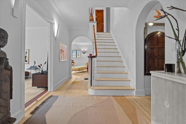 2737 Palisade Ave, Bronx, NY 10463 - entrance foyer with arched walkways, wood finished floors, baseboards, crown molding, and stairs