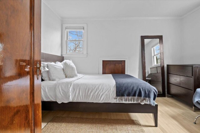 2737 Palisade Ave, Bronx, NY 10463 - bedroom with light wood-style floors, multiple windows, and ornamental molding