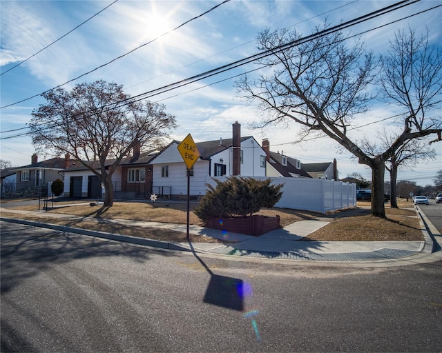 view of front of house with fence and a residential view