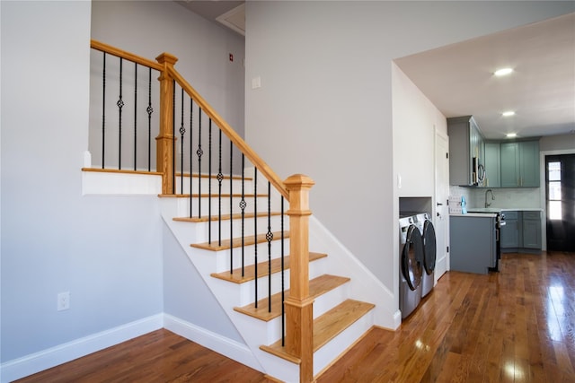 stairs featuring recessed lighting, wood-type flooring, baseboards, and independent washer and dryer