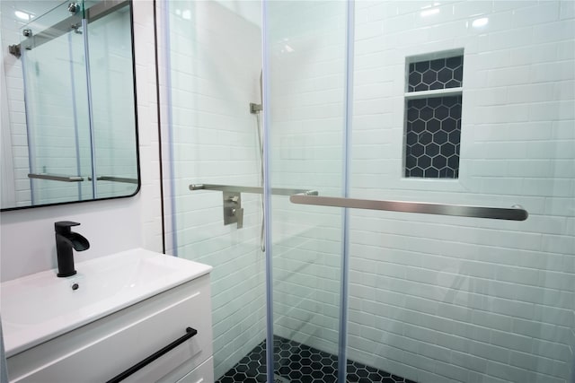 full bath with a shower stall and vanity