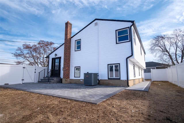 back of property featuring a patio area, a gate, a fenced backyard, and central air condition unit