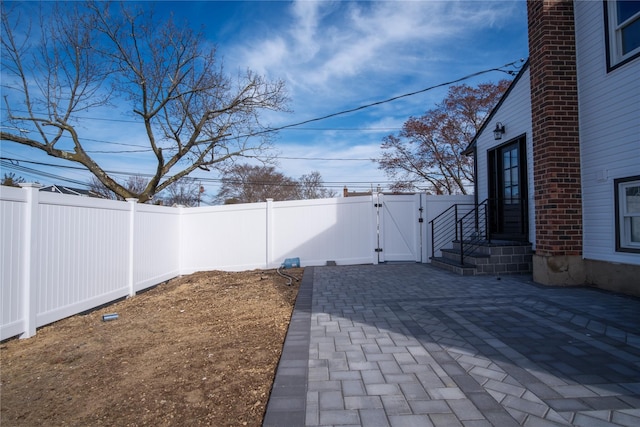 exterior space featuring a fenced backyard and a gate