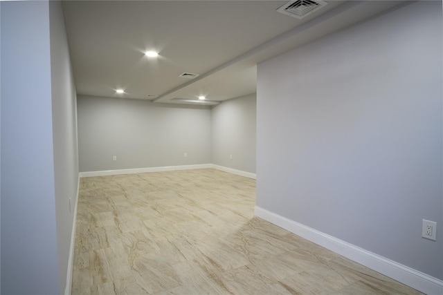 finished below grade area featuring recessed lighting, visible vents, and baseboards