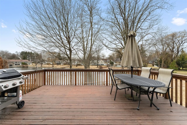 wooden terrace with outdoor dining space and area for grilling