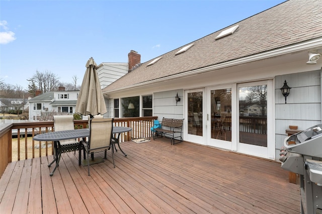 deck with outdoor dining area and french doors