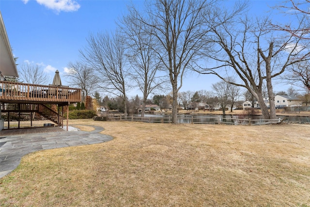 view of yard with fence, stairway, a patio, and a wooden deck