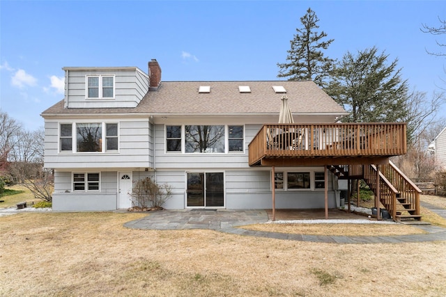 back of property featuring a chimney, a lawn, stairway, a patio area, and a wooden deck