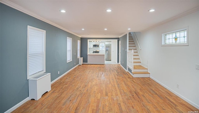 unfurnished living room with baseboards, radiator, light wood-style flooring, stairway, and ornamental molding