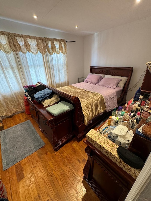 bedroom with light wood-style floors and recessed lighting